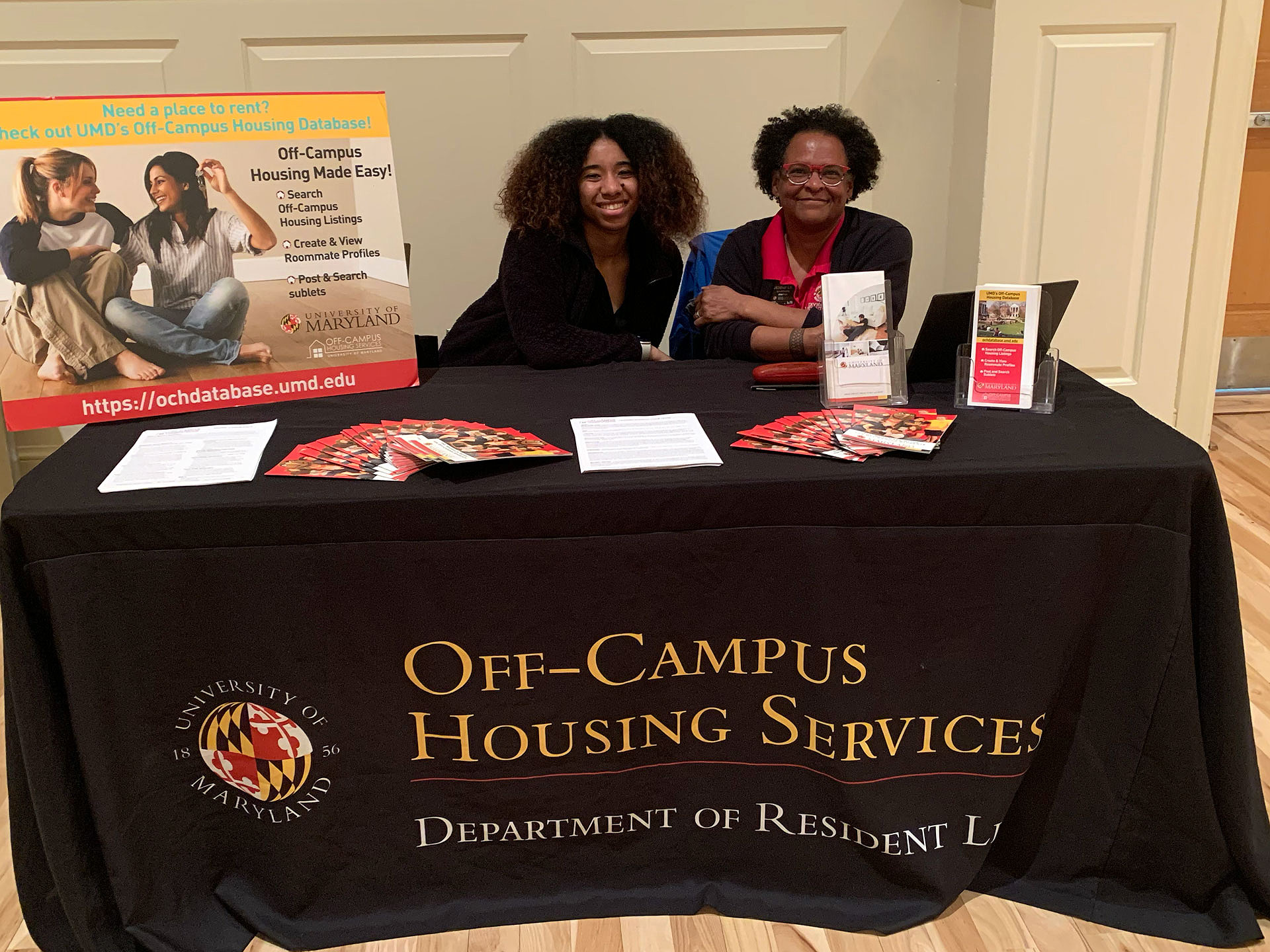 two Resident Life staff members at the Off-Campus-Housin Services table during the fair